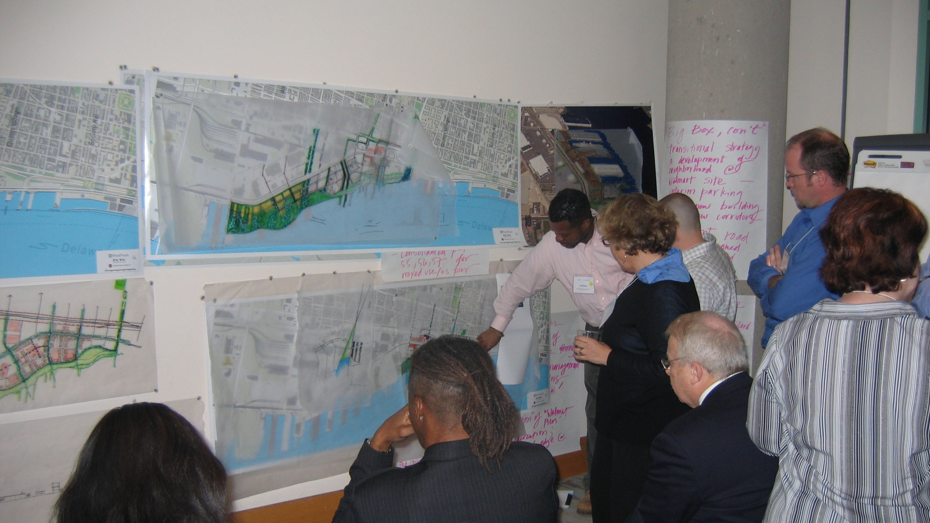 Project participants look at and discuss different maps of possible designs for the Delaware riverfront.