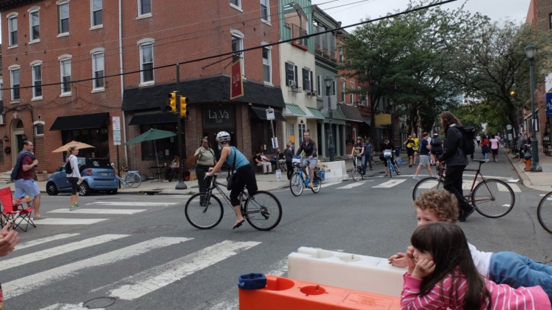 Intersection in Philadelphia with people hangout out in it.