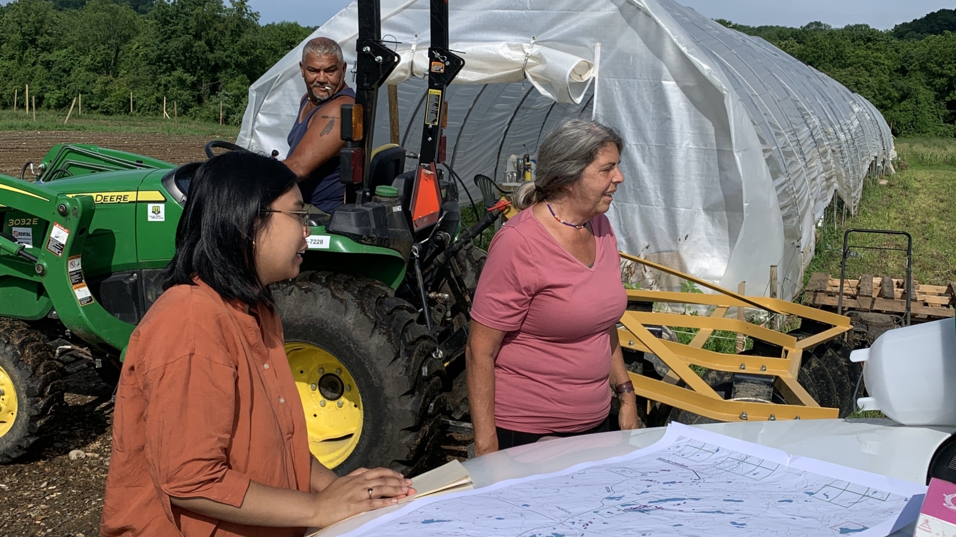 People looking at maps on a farm