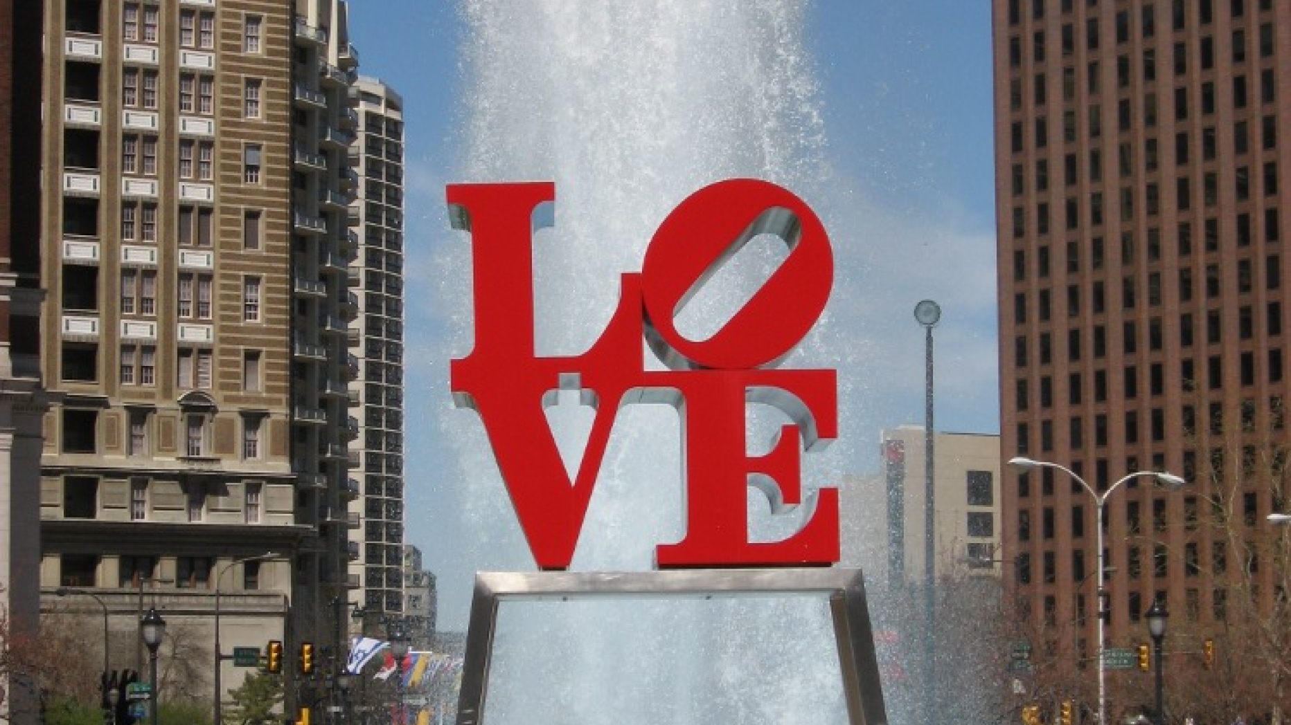 LOVE statue in Love park with fountain behind.