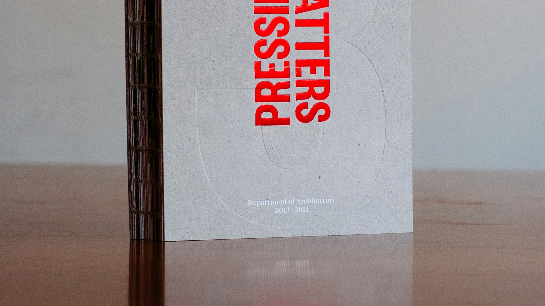 Publication 'Pressing Matters 3" Stood on end on wooden table.