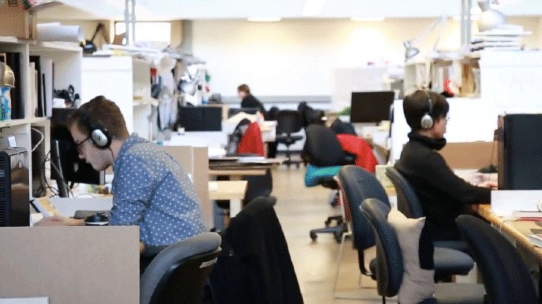 Computer lab with several students working and wearing headphones.