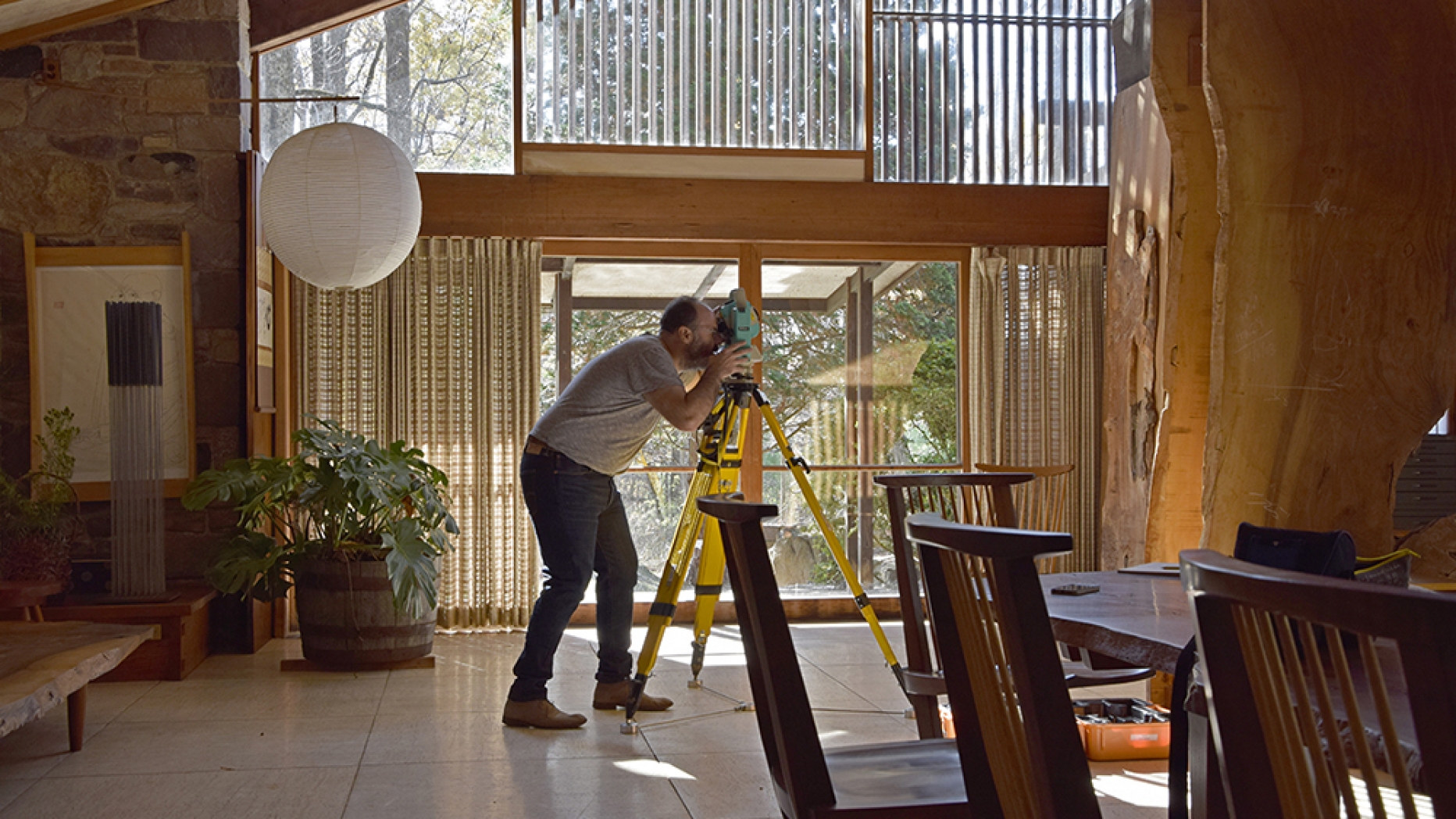 Conservationist taking photograph at George Nakashima house in main room