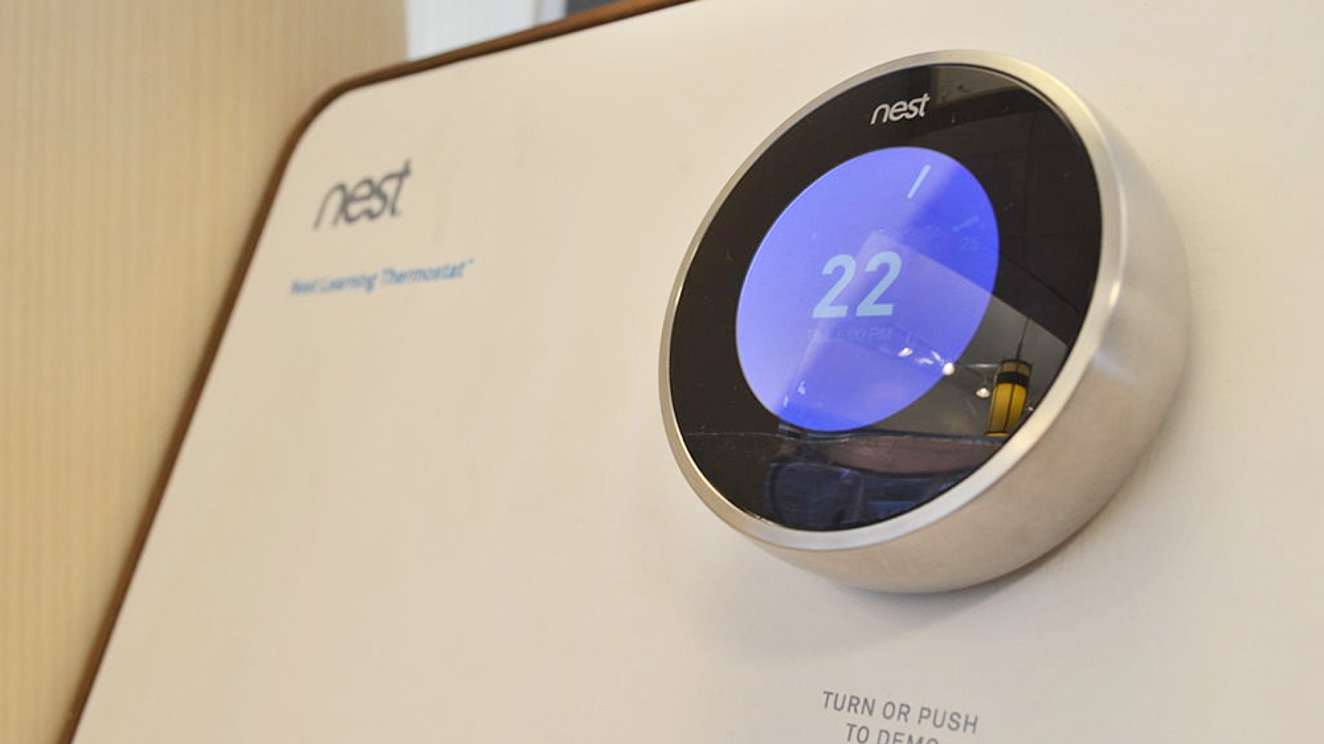 Nest thermostat with round display showing 22 degrees