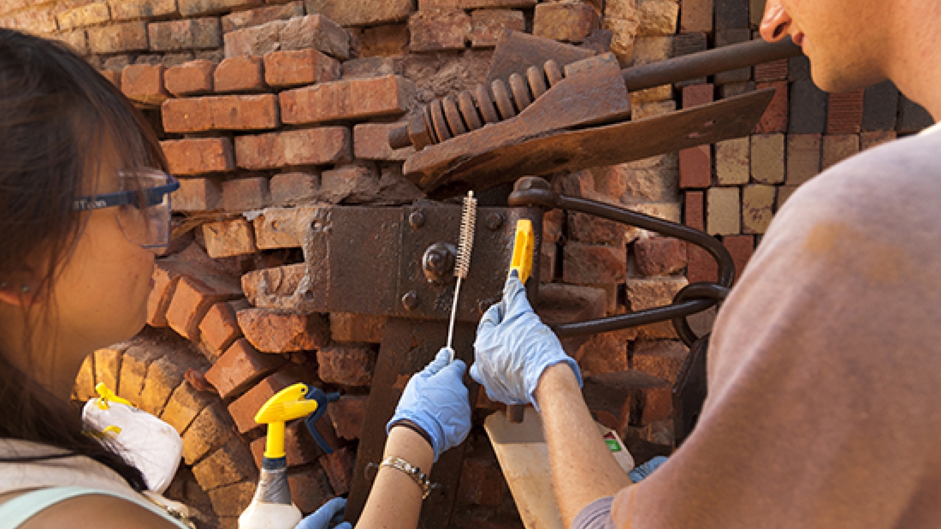 Two students working on a historic restoration and conservation project.