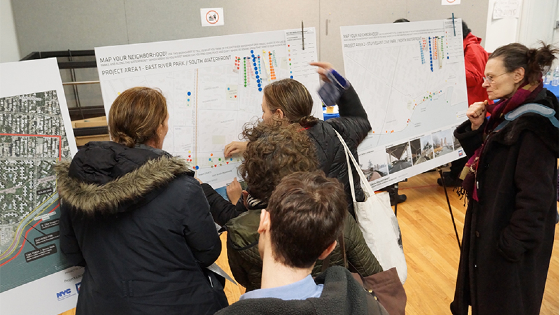 Students reading a poster board display.