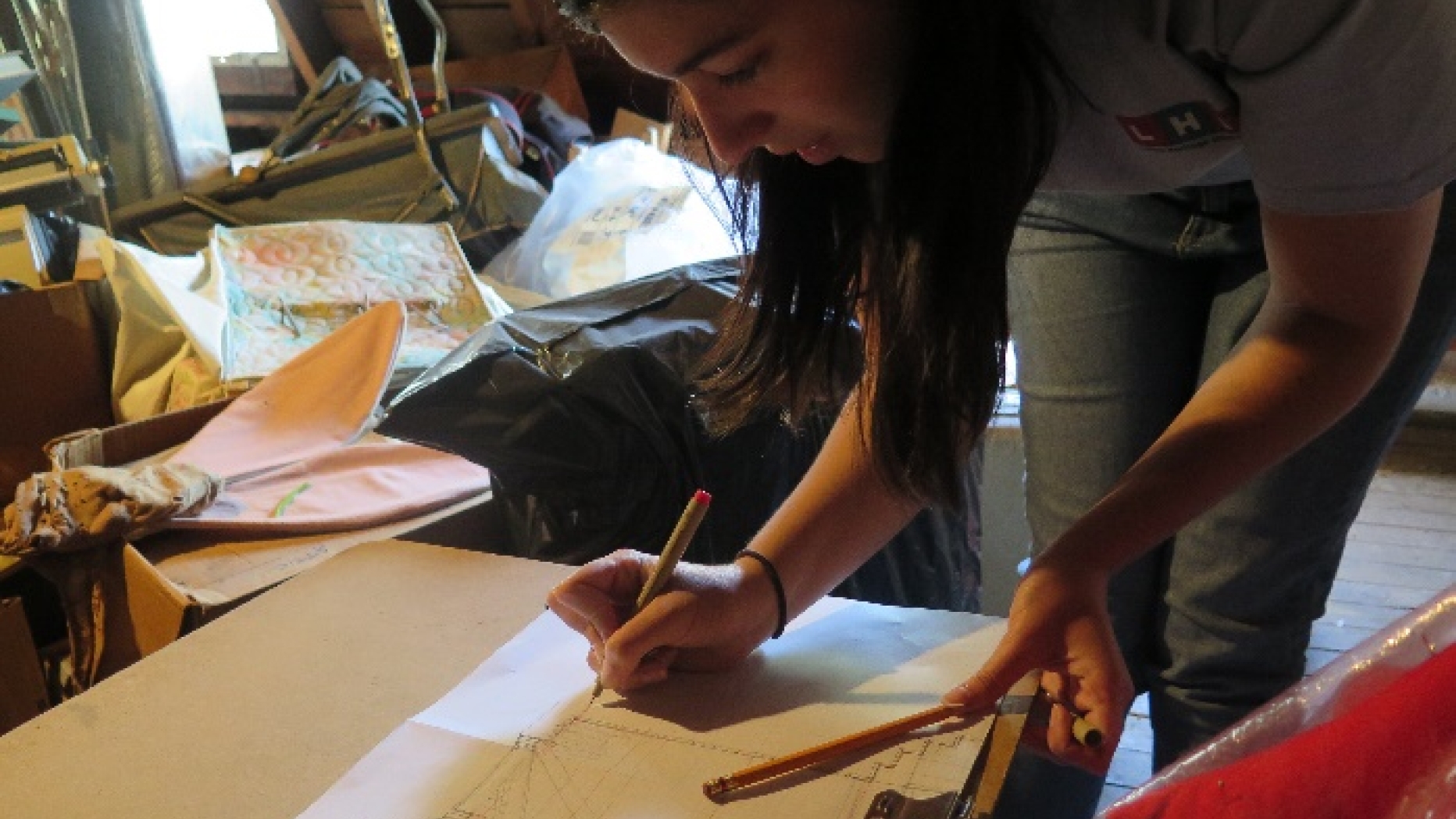 Student adding measurements to a field drawing.