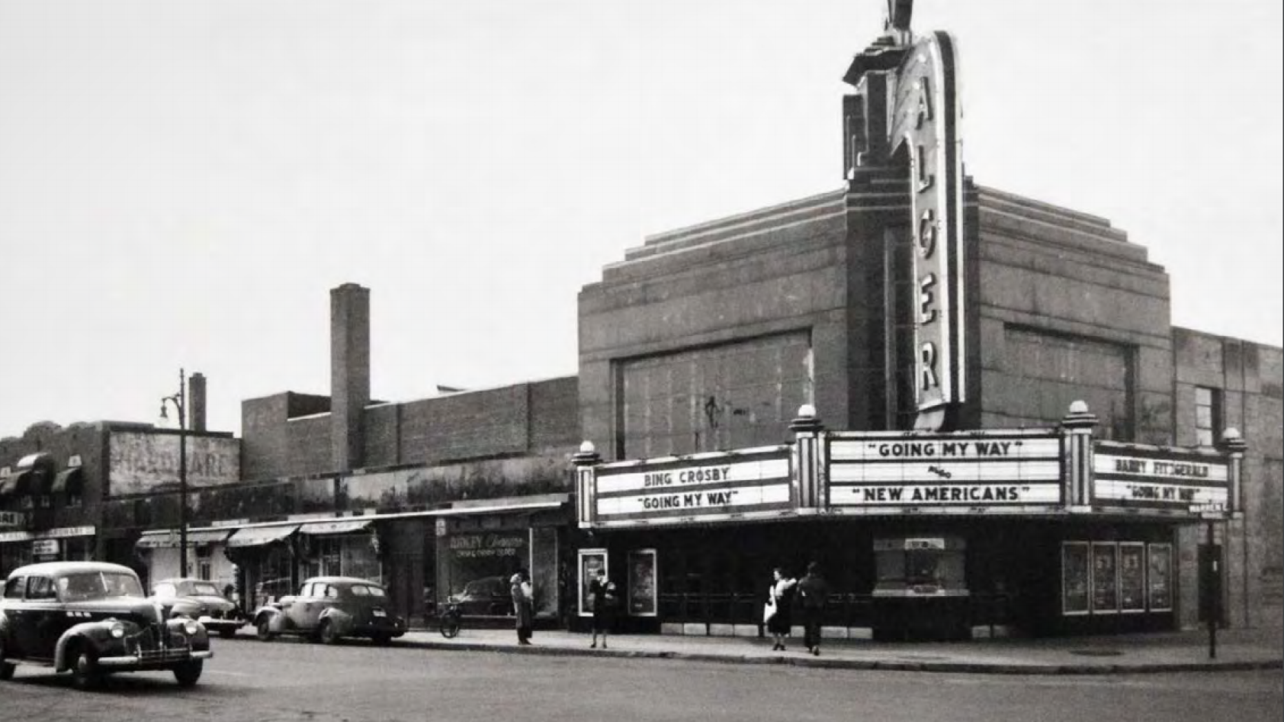 Black and white photo of a street corner in midcentury Detroit