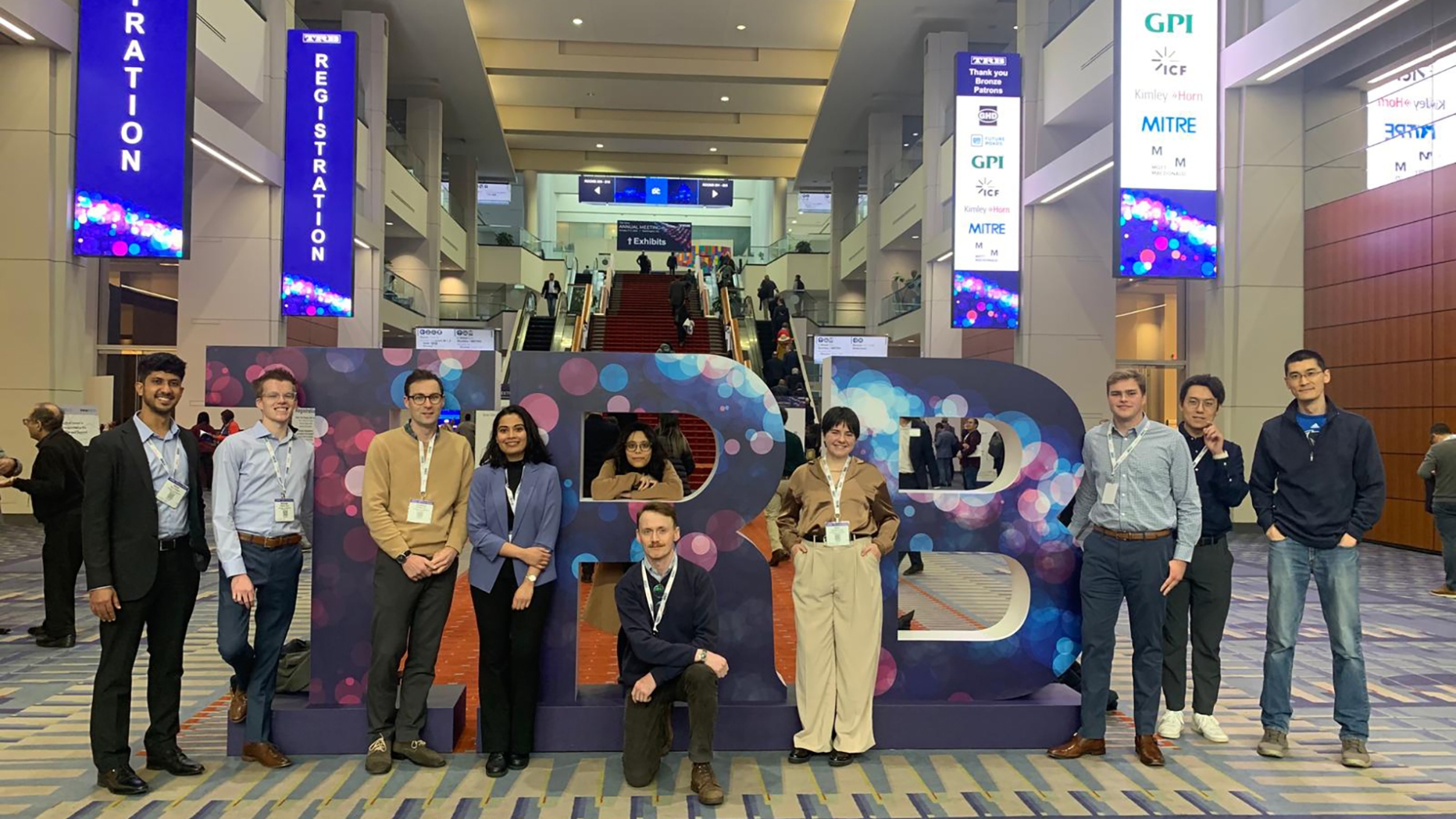 Group of people pose for photo in lobby space