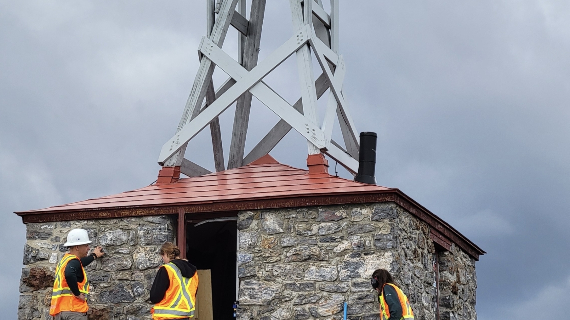 Parks Canada workers conducting a condition assessment and window and deck removal on the observatory