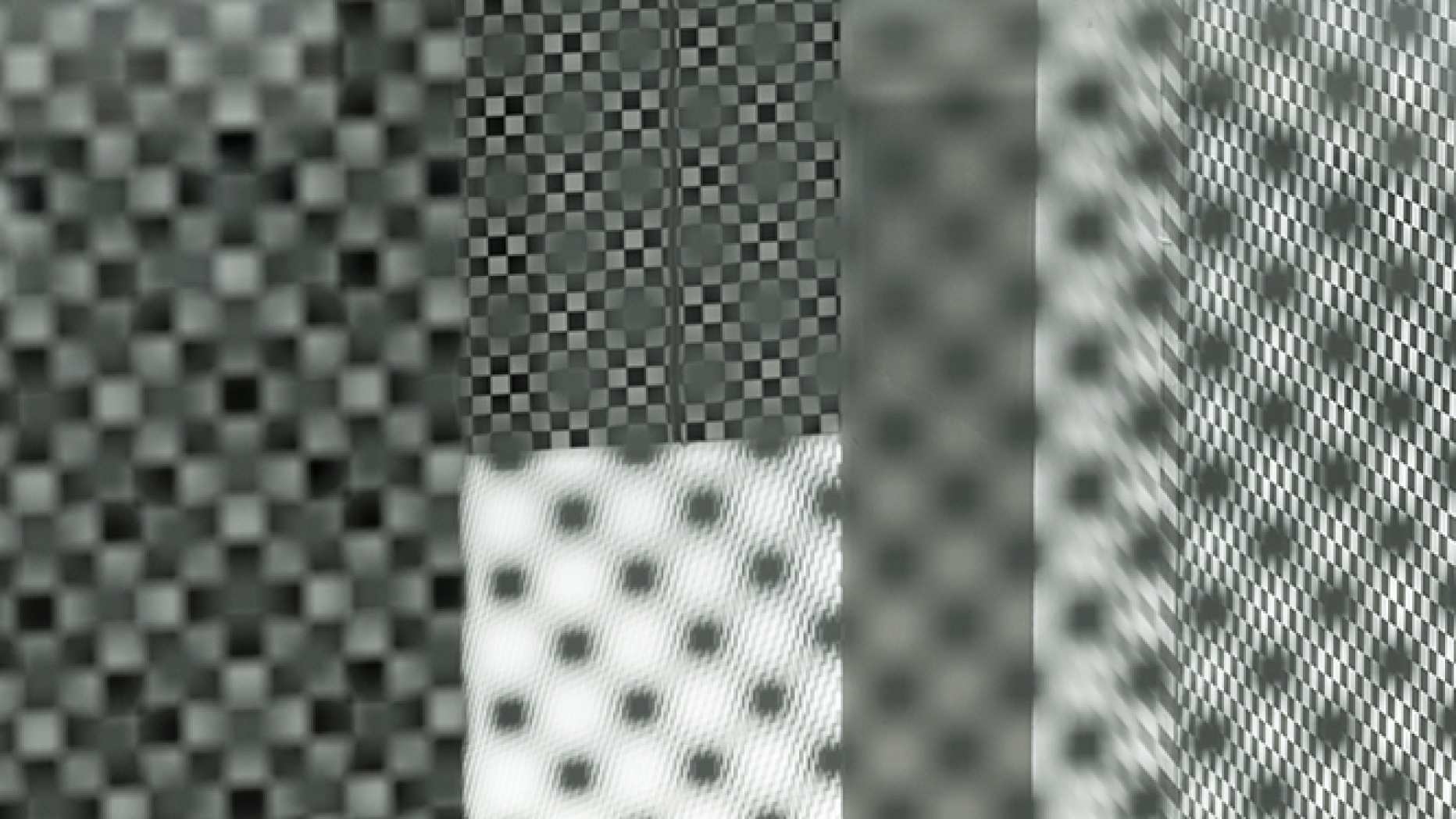 Complex abstract photo showing many layers of surfaces covered in repeating patterns and markings
