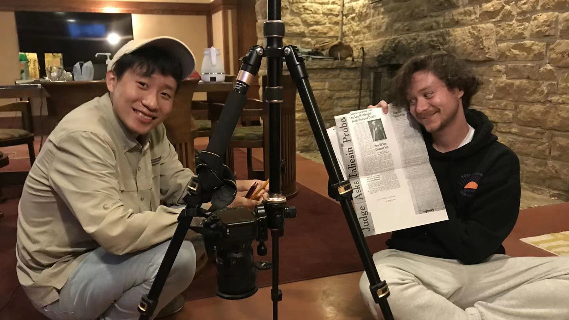 Shixin Zhao and Colin Cohan working on archival records.