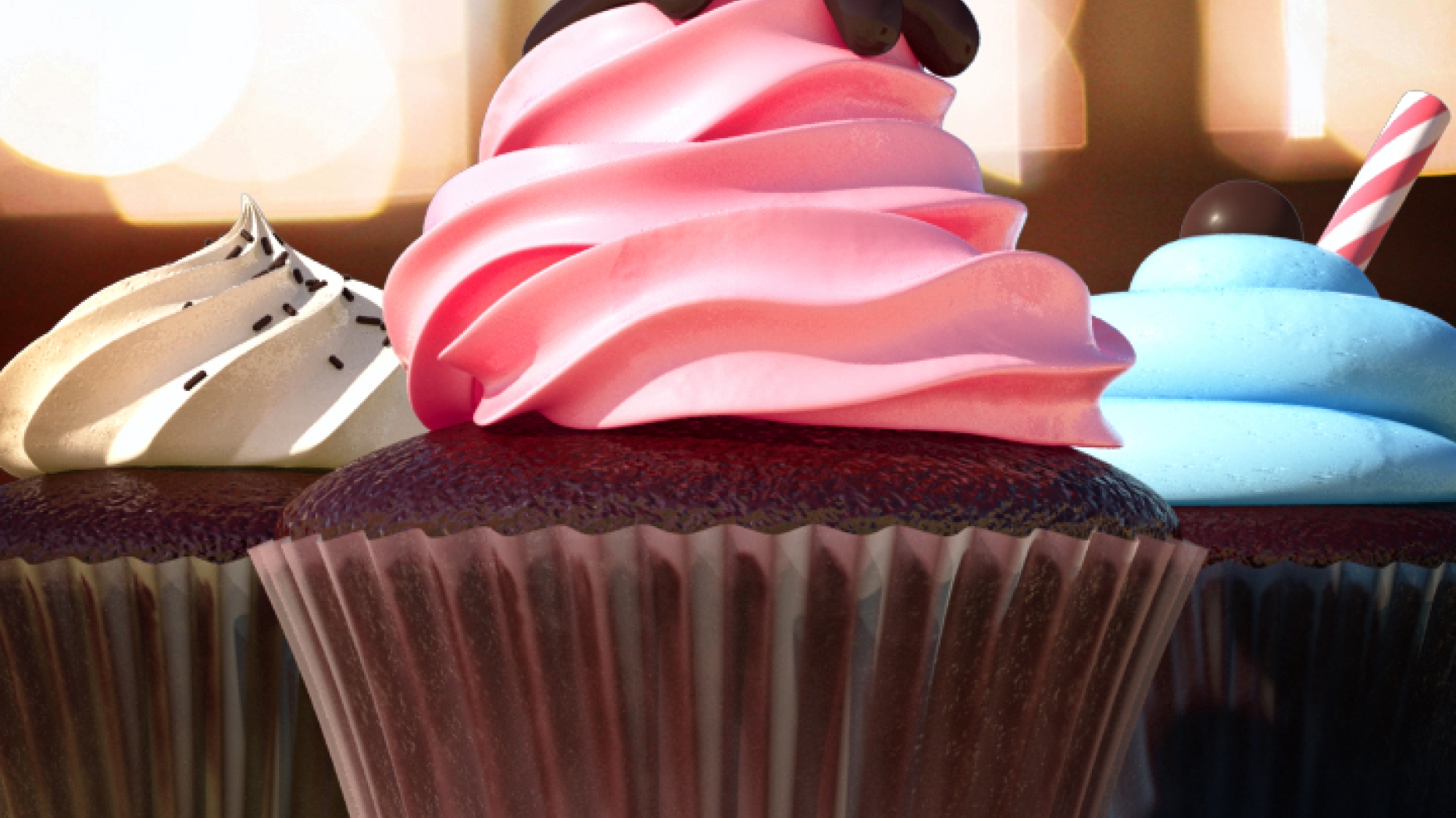 CGI graphic of three different chocolate cupcakes. One has blue icing with a candy cane sticking out. One has pink icing with chocolate syrup and a cherry on top. The third has white icing with chocolate sprinkles.