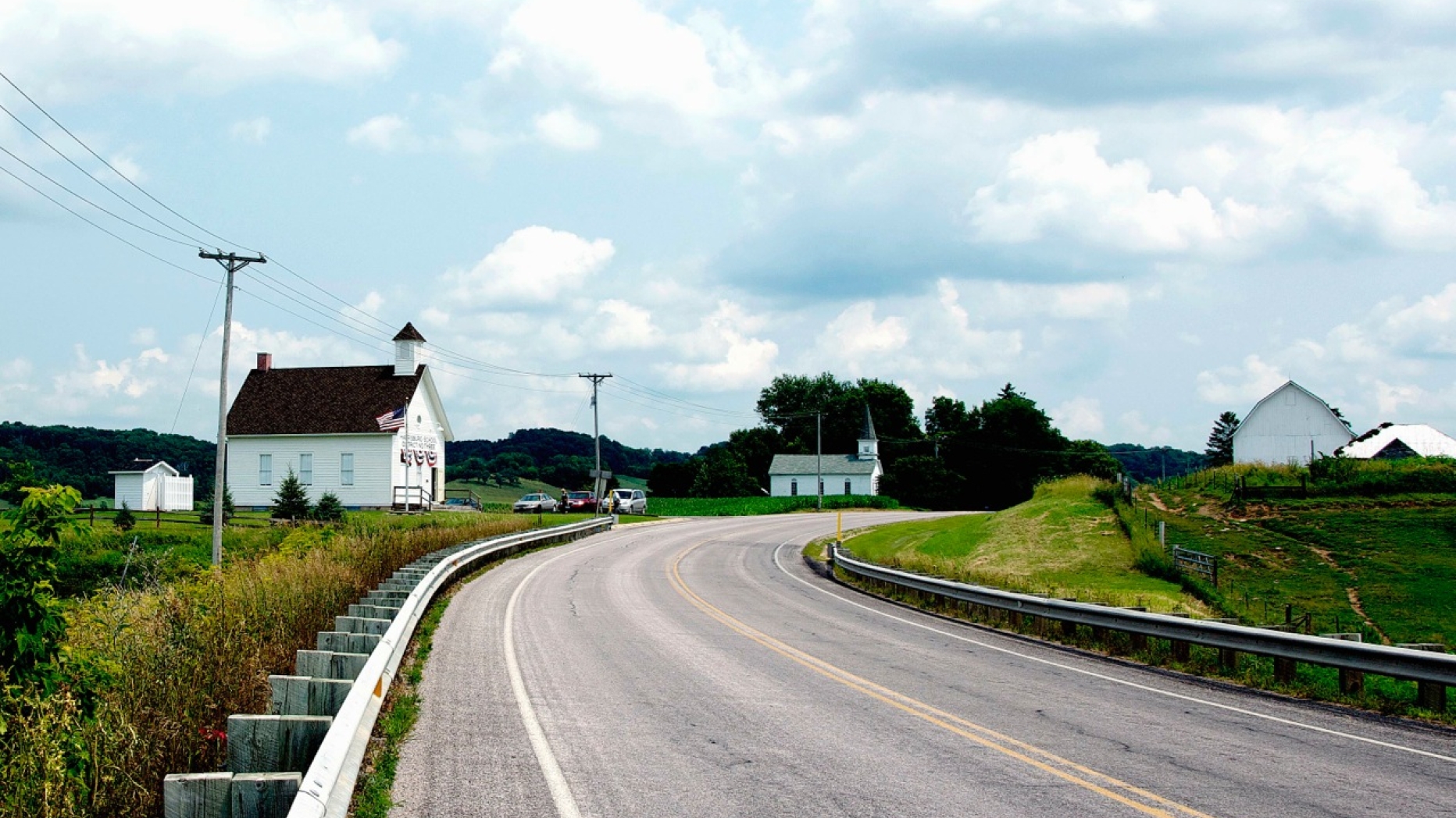 Photograph of section of highway and several houses representing classic American architecture.