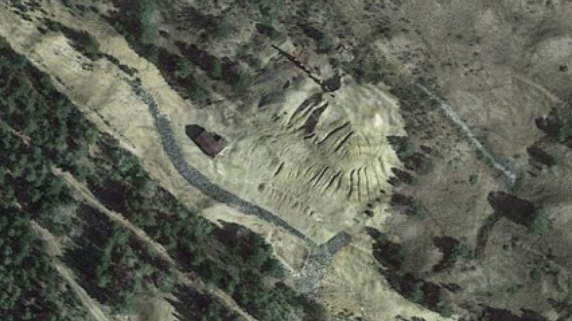 Satellite view of industrial mining dump. Border between green space and contaminated space is clearly defined