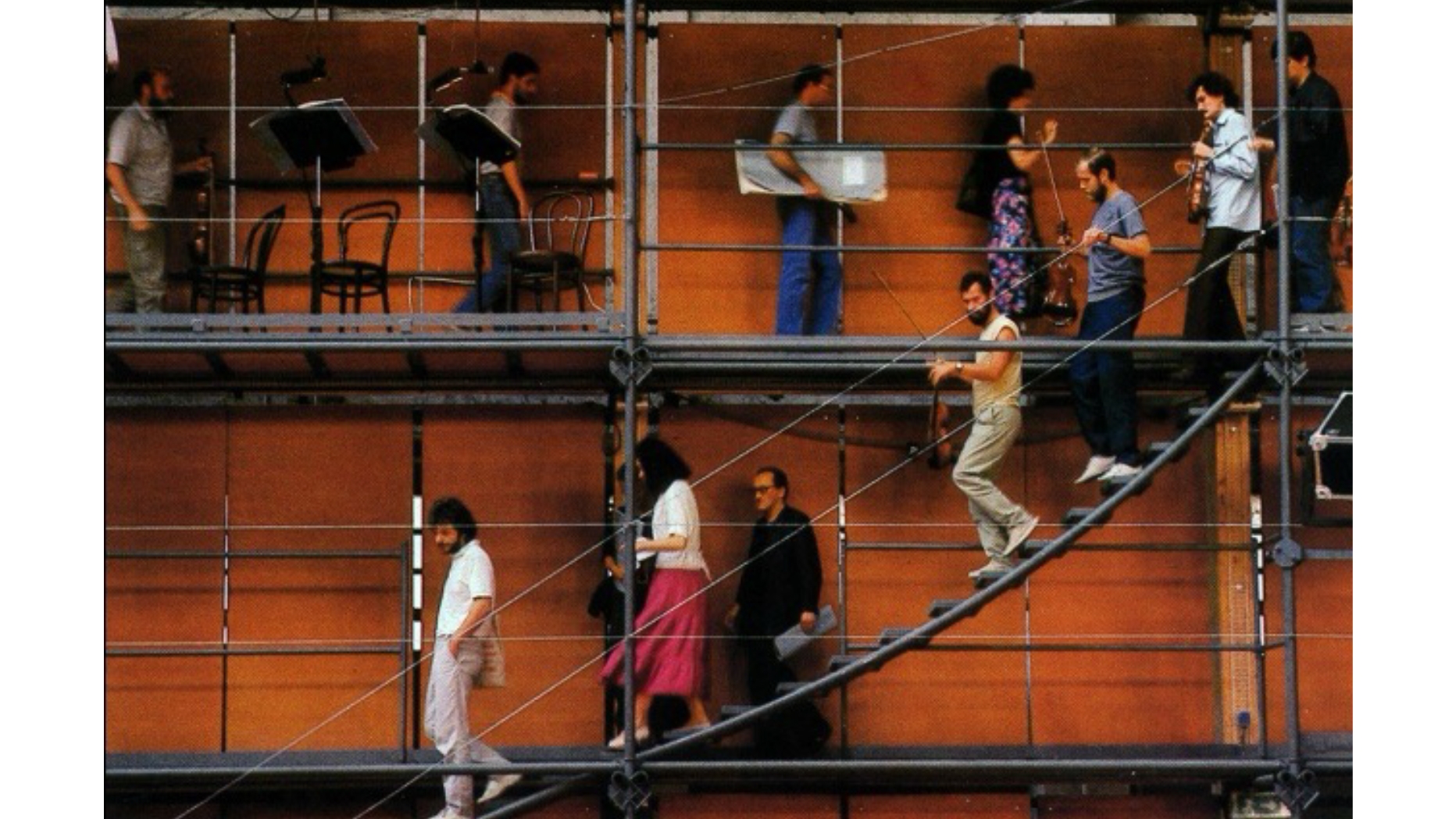 Renzo Piano’s “Ark” for Prometeo: A Tragedy of Listening. Photograph of musicians practicing walking around the audience below. Moving sound source creates a sense of space. Image from Pellisier, Alain. “Entretien Avec Renzo Piano.” Techniques et Architecture. (1985) Page 104