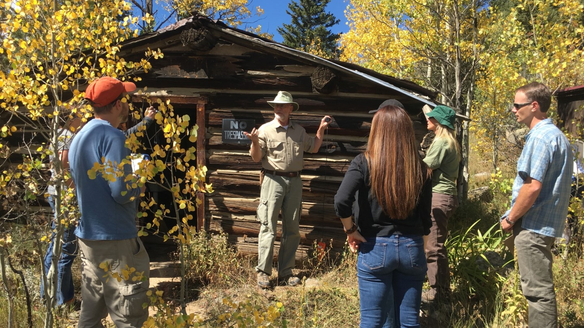 People talking outside cabin.