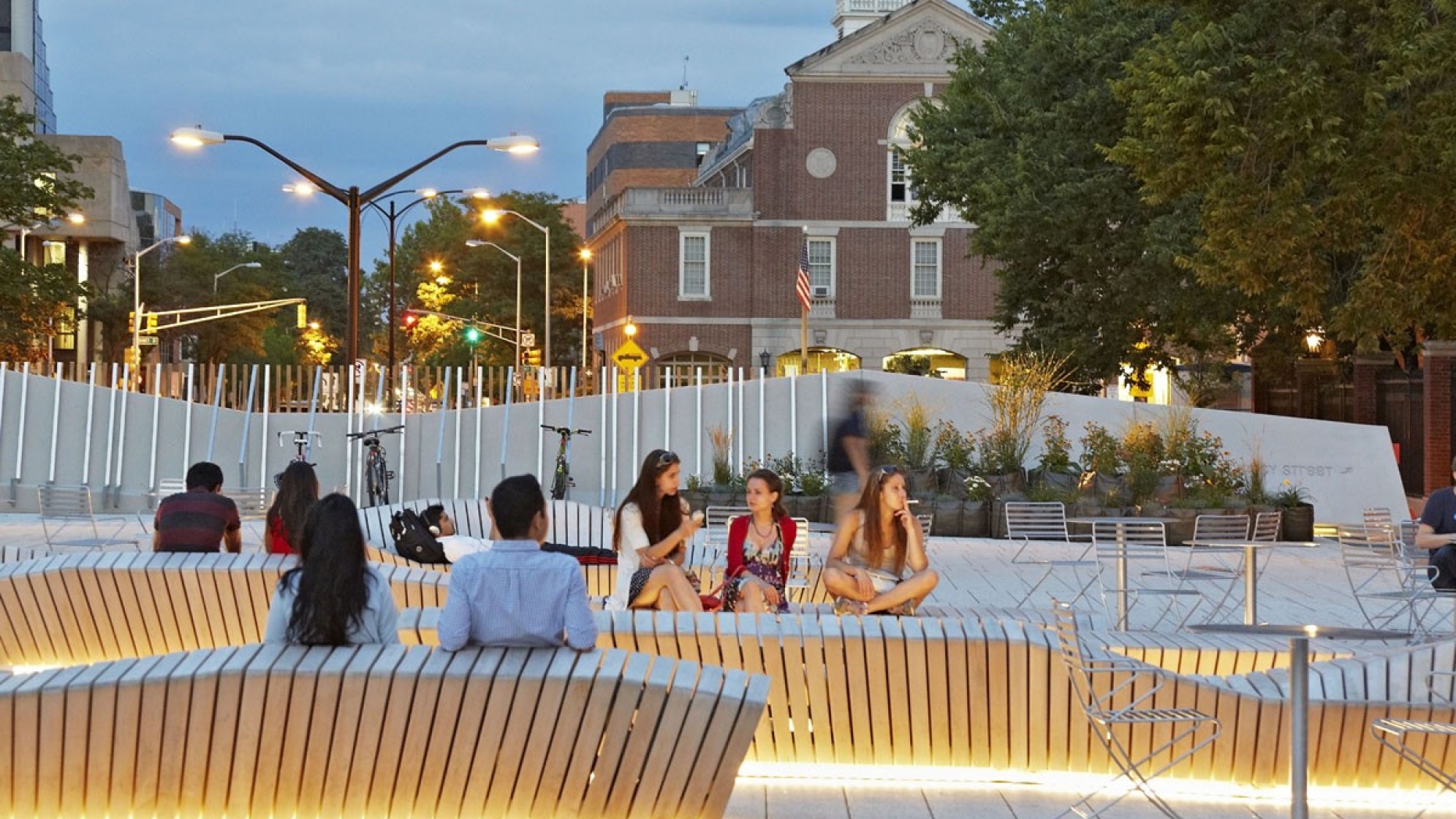 The plaza at Harvard with people using a large public seating area.