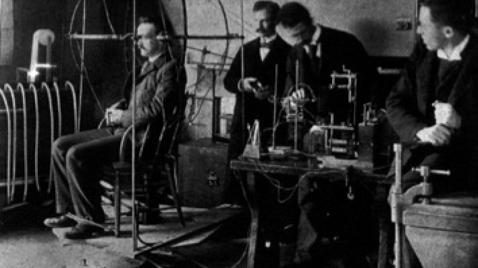 Old black and white photo of group of men performing artistic and psychological experiments.