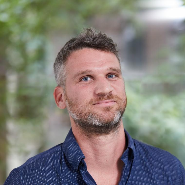 Headshot of Daniel Markiewicz wearing a blue shirt