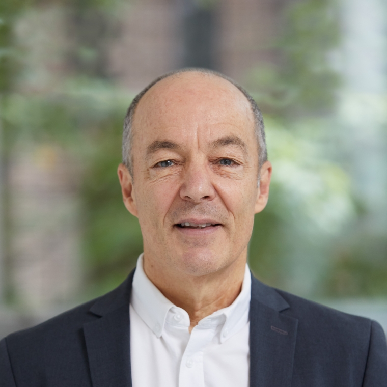 Headshot of Bill Braham wearing a suit jacket and white shirt