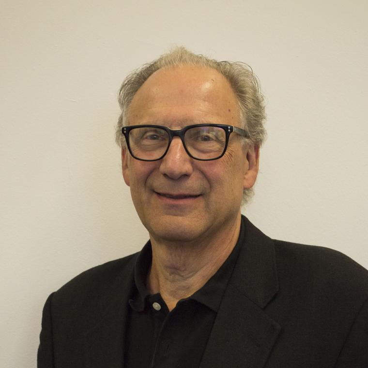 Larry Mitnick head and shoulders facing the camera with dark rimmed glasses