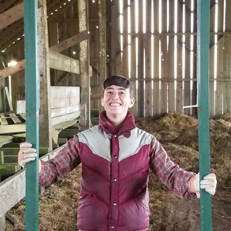 Meg in a barn holding a frame