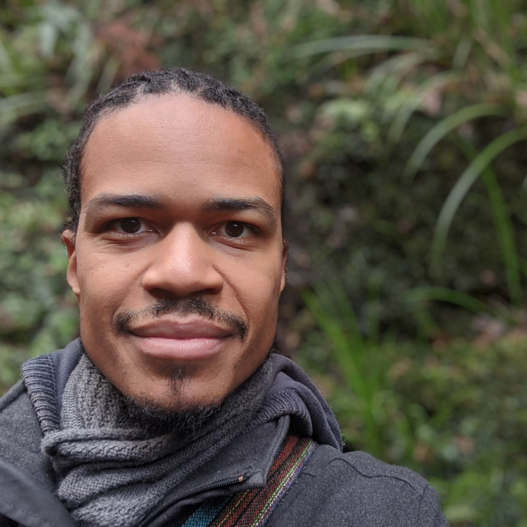 photo of Mjumbe Poe with trees in the background