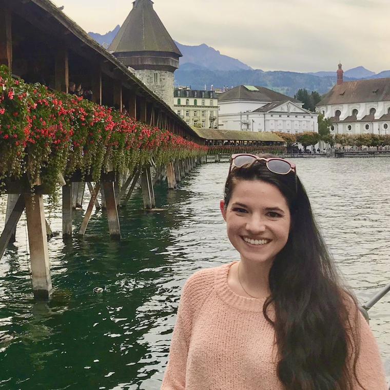 Photo of Taylor in front of an old wooden bridge