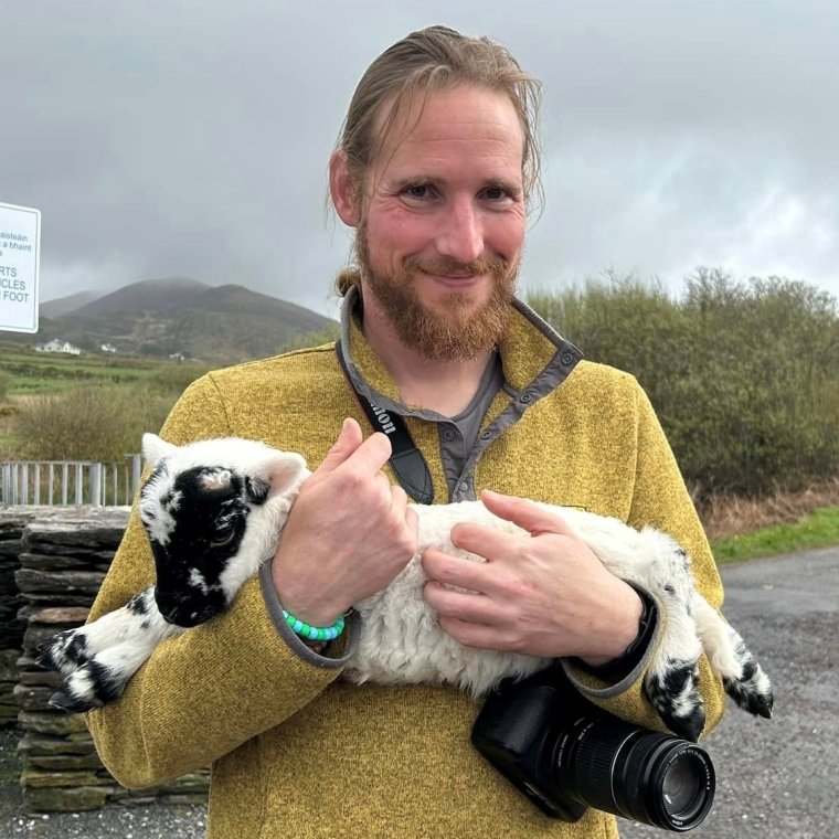 Alex Waegel holding a lamb