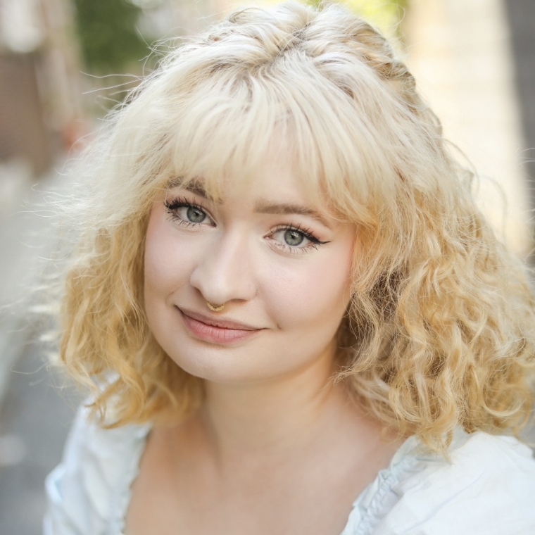 Headshot of Kaiya Sutton wearing light blue dress