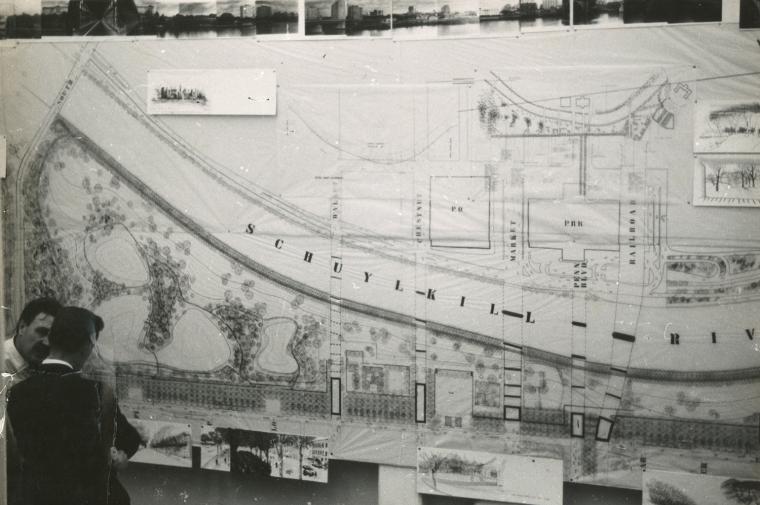 B/W photo of men standing next to blueprints of an area next to the Schuylkill