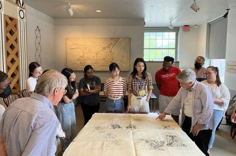 Students viewing large architectural drawing in the archives