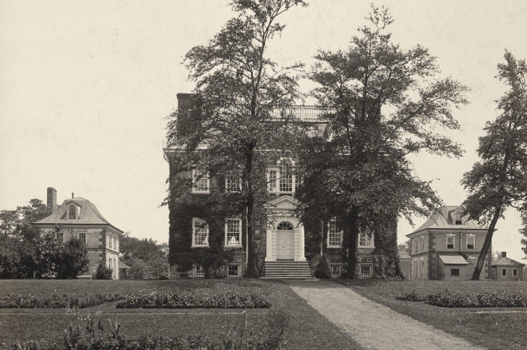 black and white image of house surrounded by lawn