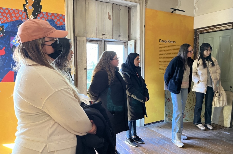 students stand in exhibit in historic house museum