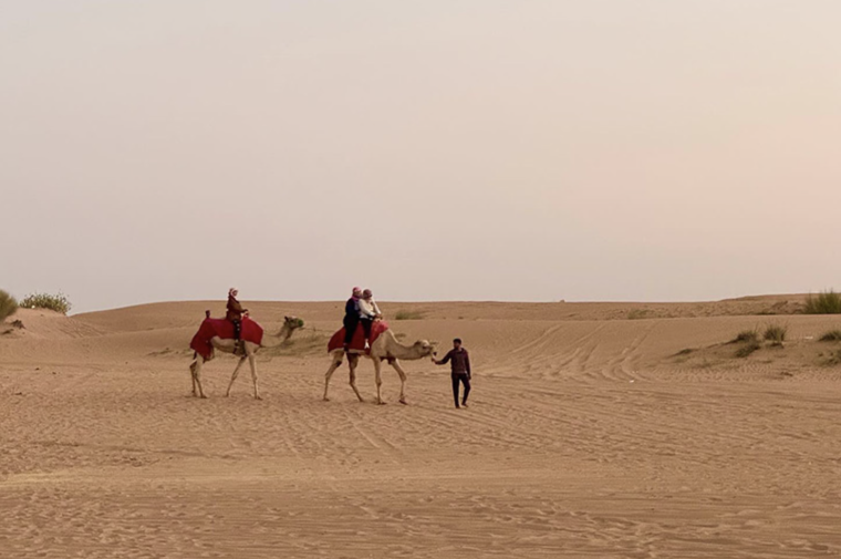 People on camels in desert