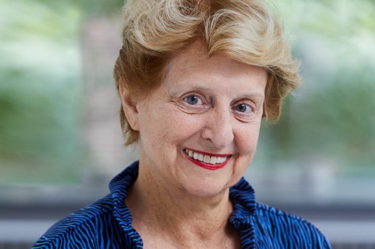 Headshot of Genie Birch wearing a blue dress