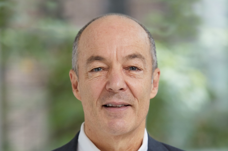 Headshot of Bill Braham wearing a suit jacket and white shirt