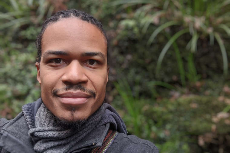 photo of Mjumbe Poe with trees in the background