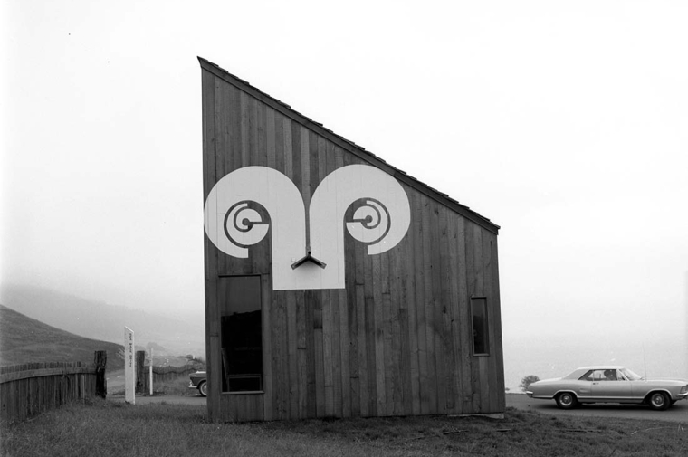 Side of wooden building with design on it similar the Aries astrological sign