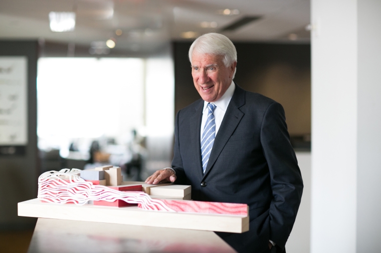 Gene Kohn stands with a table model