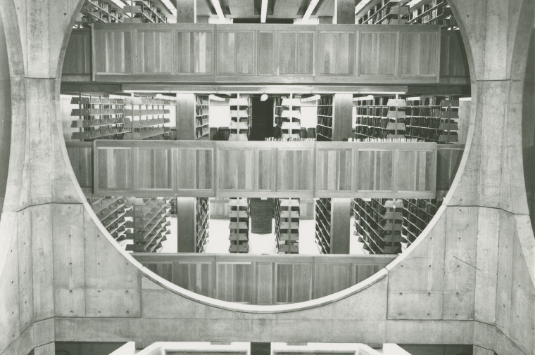Black and white photograph of interior of Louis Kahn designed Phillips Exeter Library showing circular view of book stacks