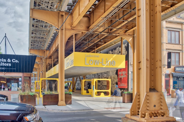 Park underneath raised railway with sign saying "Lowline"