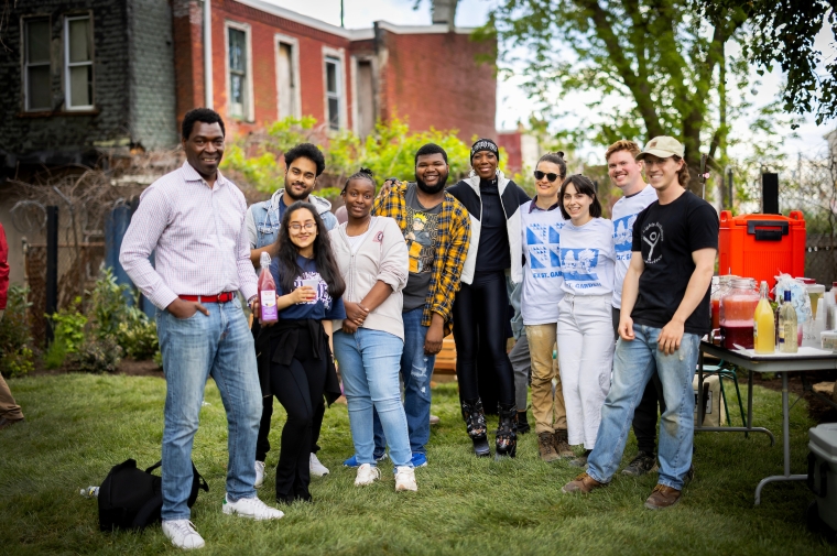 A group of young adults stand together in a park