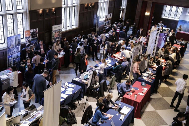 Employers greet students at rows of tables at Houston Hall 