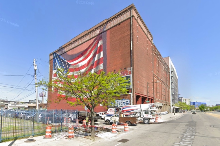 brick building with american flag mural