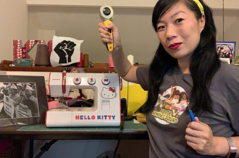 Artist Kristina Wong standing in front of Hello Kitty sewing machine.