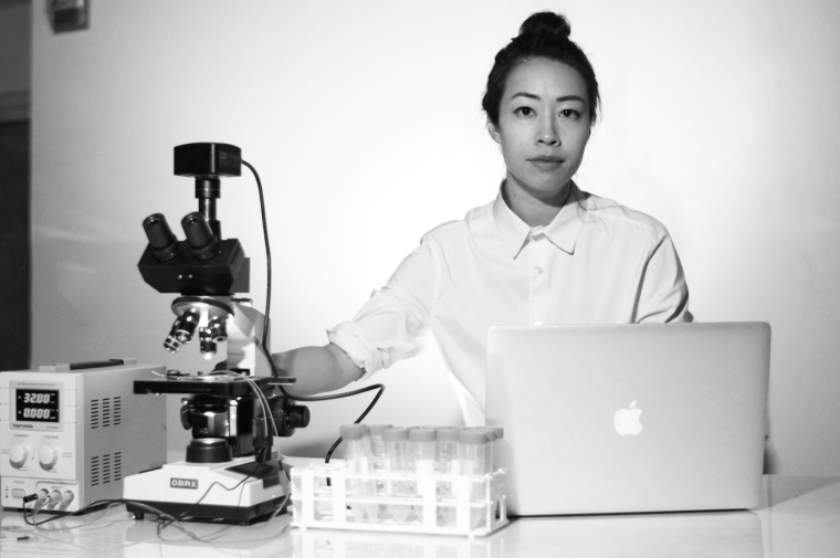 headshot of ani sitting at a desk with a computer and lap equipment