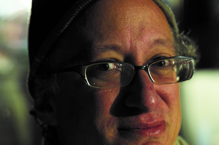 closeup of barry headshot wearing a cap and glasses