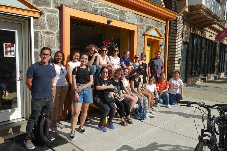 Group posing for photo outside of restaurant